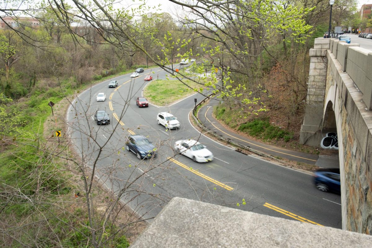 Cars drive down the Rock Creek and Potomac Parkway.