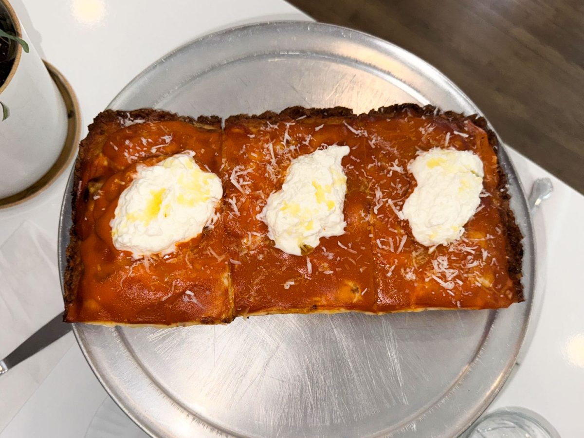 Gemini x Happy Ice Cream’s vodka sauce pizza with burrata and olive oil on top .